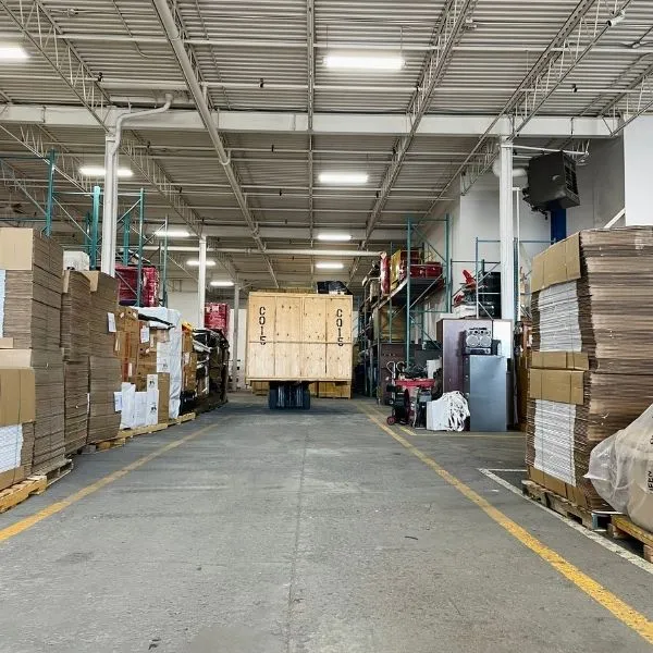 Inside the Granero Moving warehouse with crated and boxed shipments