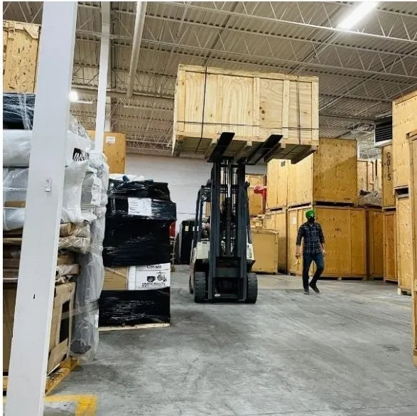 Granero Moving warehouse with forklift and crated shipments